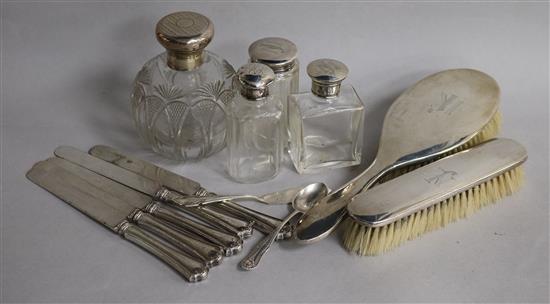 A collection of silver mounted dressing table items including brushes and jars, five silver handled knives, a spoon and butter knife